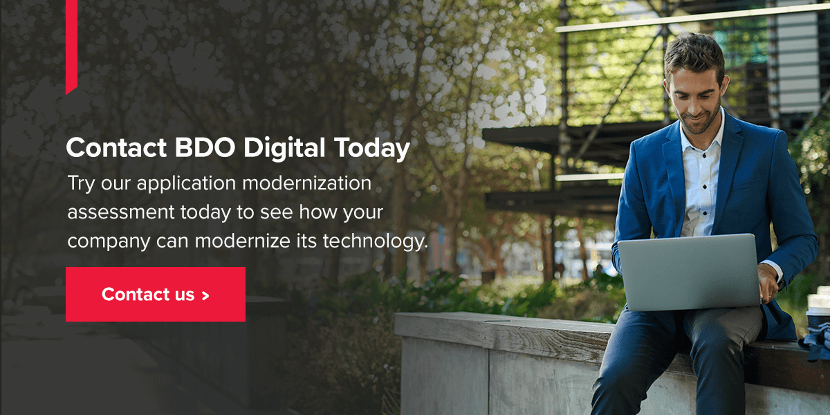 Contact BDO Digital Today. Man looking at laptop sitting outside.
